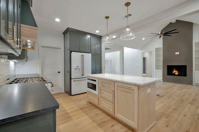 kitchen featuring visible vents, white refrigerator with ice dispenser, vaulted ceiling, light wood-style floors, and recessed lighting