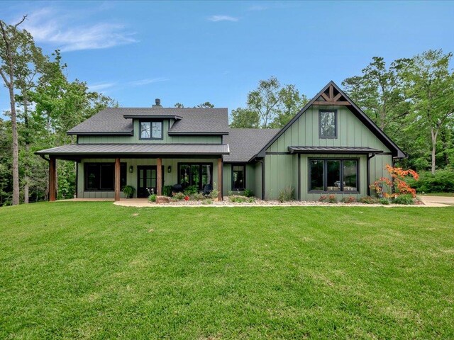 view of front facade featuring board and batten siding and a front lawn