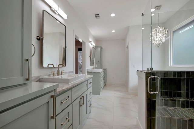 bathroom with marble finish floor, recessed lighting, two vanities, a shower stall, and a sink
