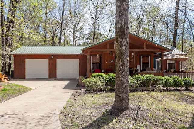 single story home featuring covered porch and a garage