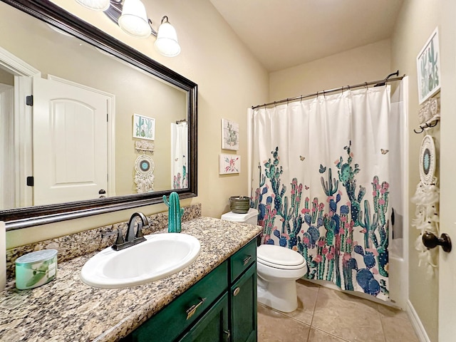 bathroom with tile patterned flooring, vanity, and toilet