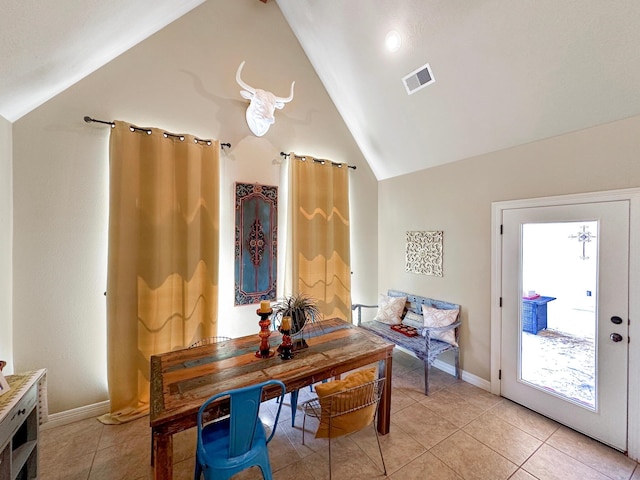 interior space featuring lofted ceiling and light tile patterned floors