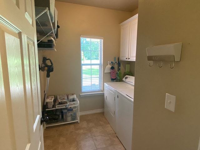 429 Derek Rd, Lufkin, TX 75904 - laundry area with washer and clothes dryer, cabinet space, light tile patterned floors, and baseboards