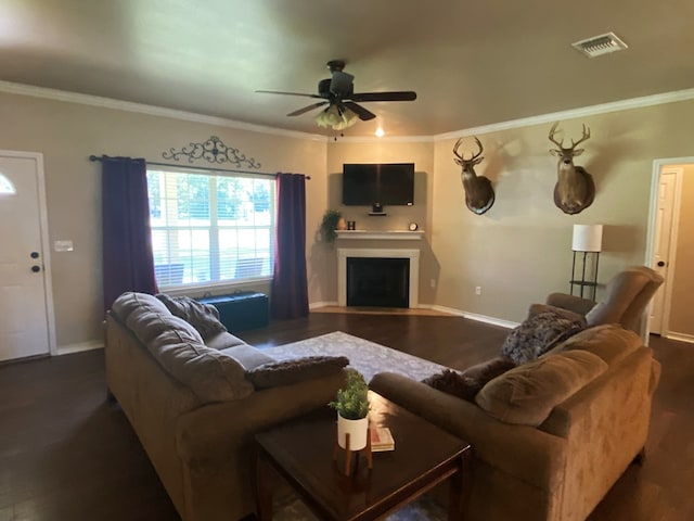429 Derek Rd, Lufkin, TX 75904 - living area featuring dark wood-style flooring, a fireplace, crown molding, ceiling fan, and baseboards
