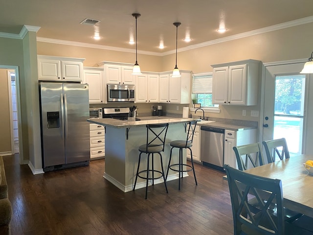 429 Derek Rd, Lufkin, TX 75904 - kitchen with appliances with stainless steel finishes, a kitchen breakfast bar, a sink, white cabinets, and crown molding