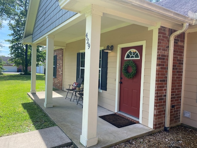 429 Derek Rd, Lufkin, TX 75904 - entrance to property with brick siding, covered porch, a yard, and roof with shingles