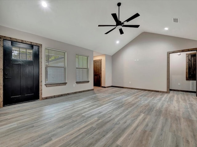 unfurnished living room featuring ceiling fan, light wood-type flooring, and lofted ceiling