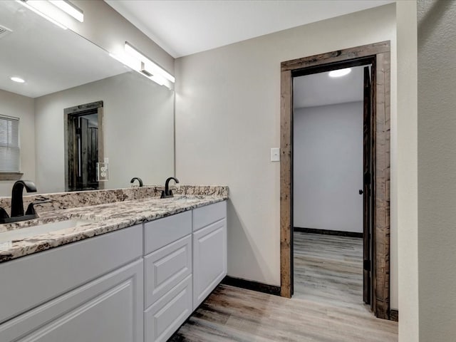 bathroom with hardwood / wood-style floors and vanity