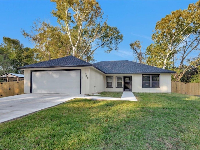 single story home featuring a front yard and a garage