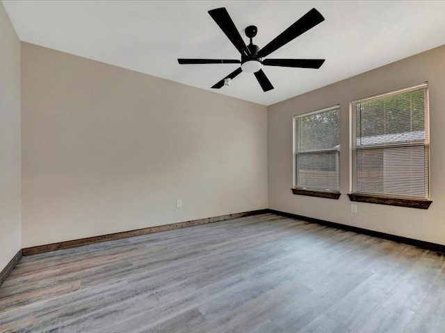 empty room featuring ceiling fan and light hardwood / wood-style flooring