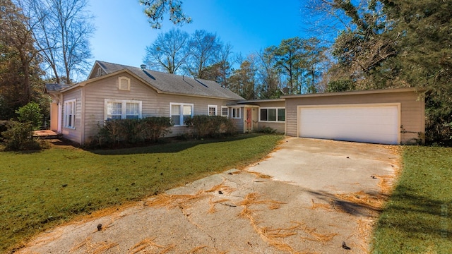 511 1st, Jasper, TX 75951 - view of front of house featuring driveway, a front lawn, and a garage