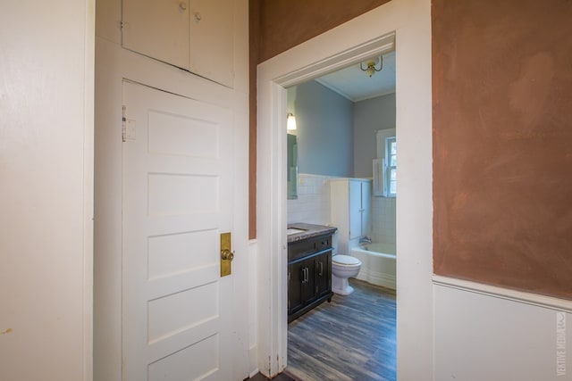 511 1st, Jasper, TX 75951 - corridor featuring dark wood-style floors and a wainscoted wall