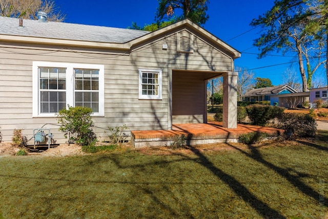 511 1st, Jasper, TX 75951 - back of house featuring a yard, covered porch, and a shingled roof