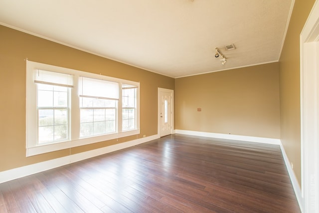 511 1st, Jasper, TX 75951 - unfurnished room featuring dark wood finished floors, crown molding, and rail lighting