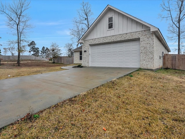 view of side of home with a garage and a yard