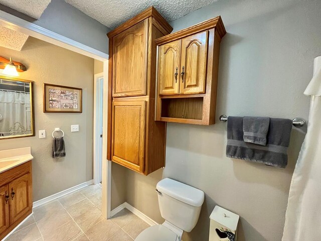 bathroom with a textured ceiling, toilet, shower / bath combo with shower curtain, and tile patterned floors