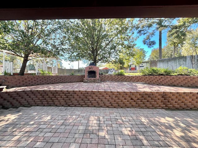 view of patio / terrace featuring an outdoor brick fireplace