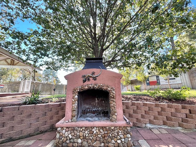 view of patio / terrace with an outdoor stone fireplace