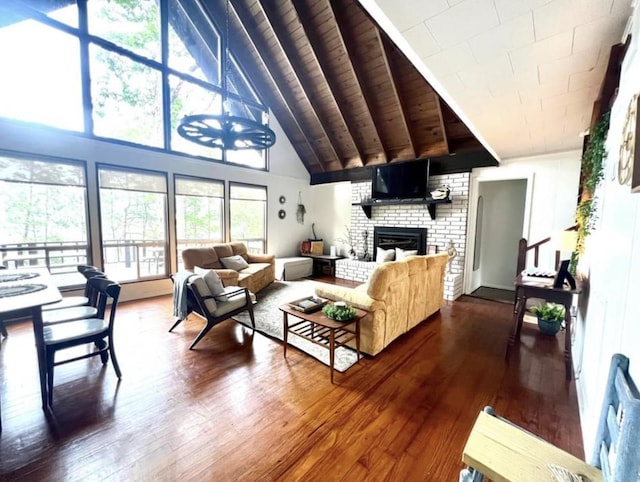 living room with hardwood / wood-style flooring, lofted ceiling, and a fireplace