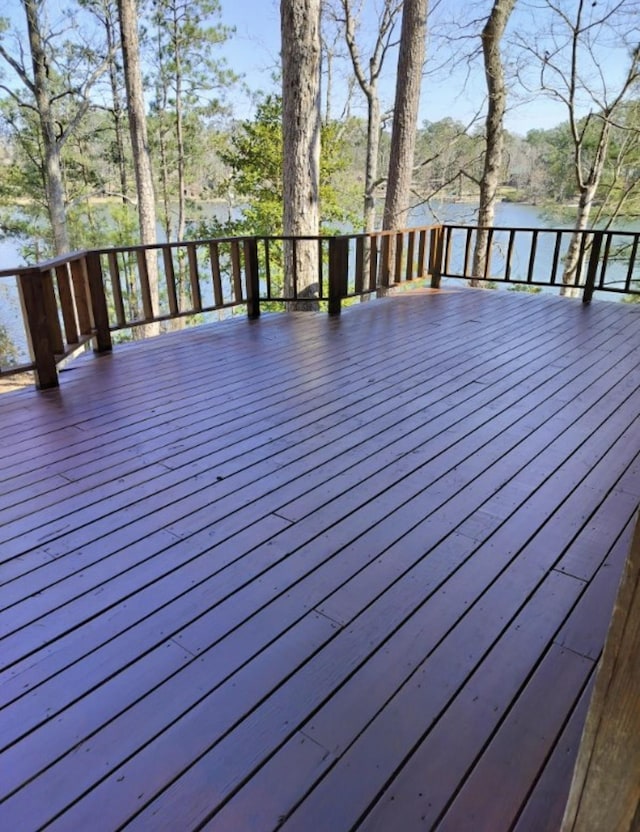 wooden deck featuring a water view