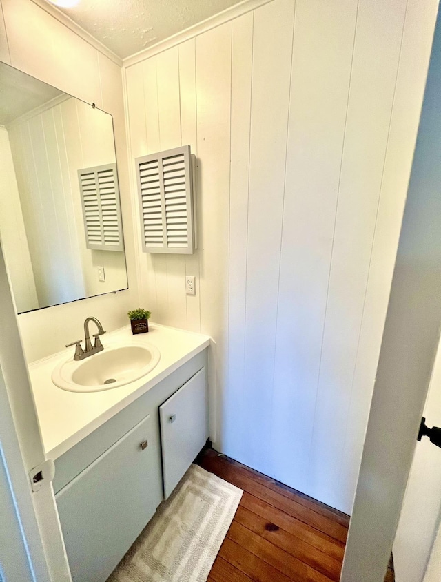 bathroom featuring a textured ceiling, vanity, and hardwood / wood-style flooring