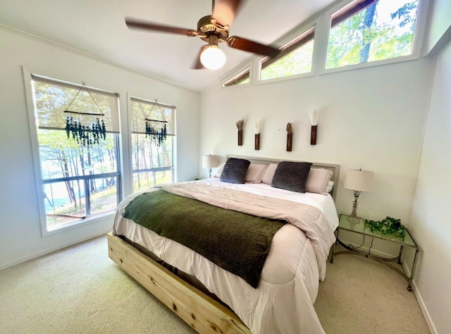 bedroom featuring lofted ceiling, carpet floors, and ceiling fan with notable chandelier