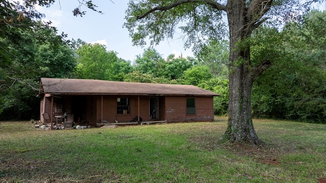 1982 County Road 836, Nacogdoches, TX 75964 - ranch-style home featuring a front lawn and a view of trees