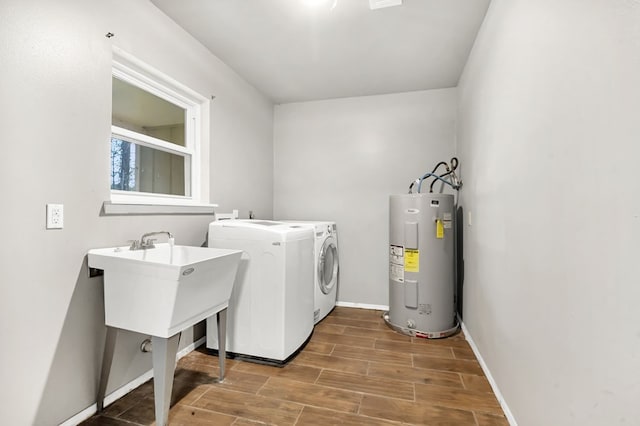 laundry room with washer and clothes dryer, dark wood-type flooring, and water heater