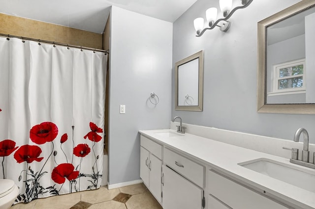 bathroom with tile patterned flooring, vanity, and toilet