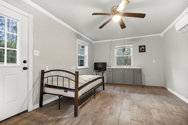 bedroom with a wall unit AC, ceiling fan, crown molding, and light hardwood / wood-style floors