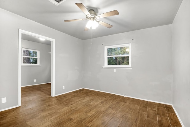 empty room with ceiling fan and wood-type flooring