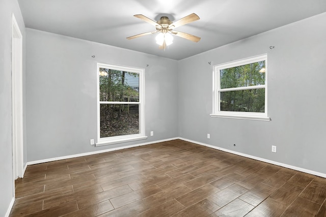 unfurnished room with ceiling fan and dark hardwood / wood-style flooring