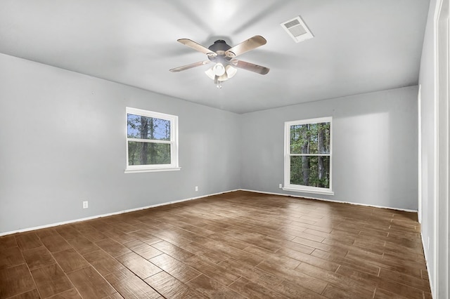 unfurnished room featuring ceiling fan and dark wood-type flooring