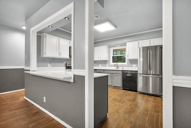 kitchen with dishwasher, dark wood-type flooring, kitchen peninsula, white cabinetry, and stainless steel refrigerator