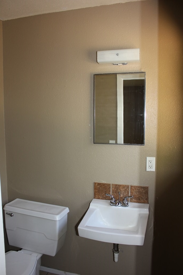 bathroom featuring sink and toilet