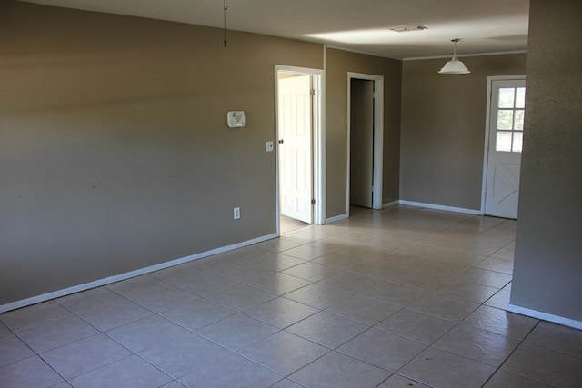 unfurnished room featuring light tile patterned flooring