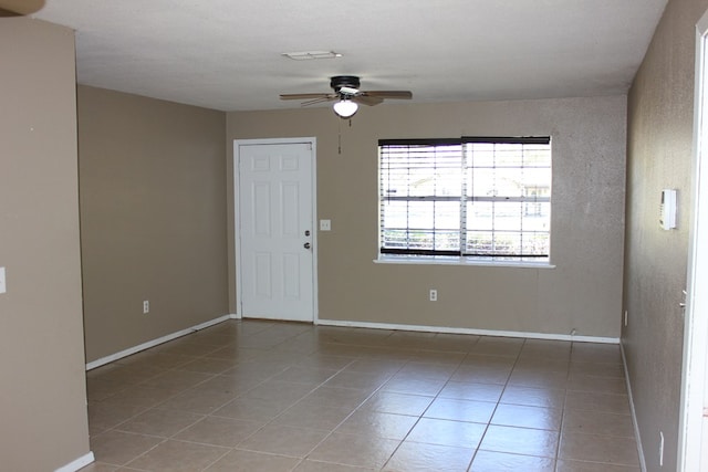 interior space with tile patterned flooring and ceiling fan