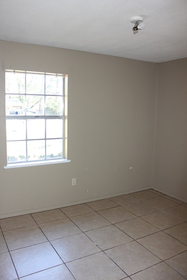 unfurnished room with light tile patterned floors