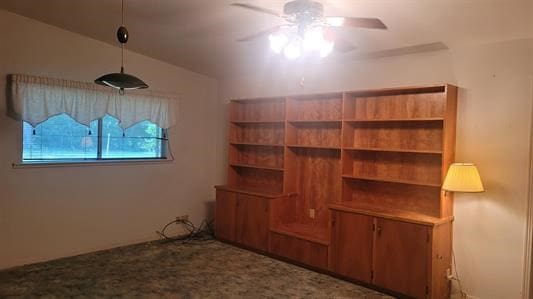 interior space featuring carpet flooring and ceiling fan