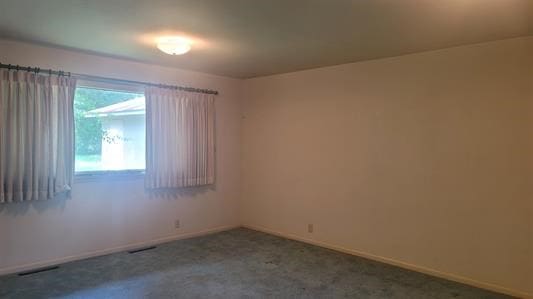 unfurnished room with carpet flooring