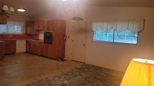 kitchen featuring vaulted ceiling, sink, and white appliances