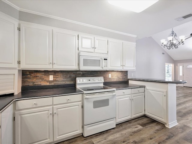 kitchen with dark countertops, white cabinets, and white appliances