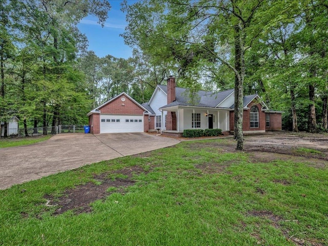 single story home with brick siding, concrete driveway, fence, and covered porch