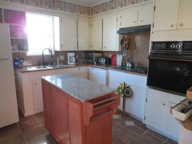 kitchen with white cabinets, sink, dark tile patterned flooring, and black appliances