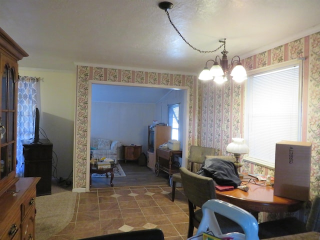 dining area featuring tile patterned flooring, crown molding, and a chandelier