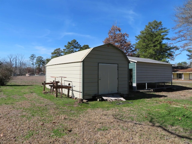 view of outbuilding with a lawn