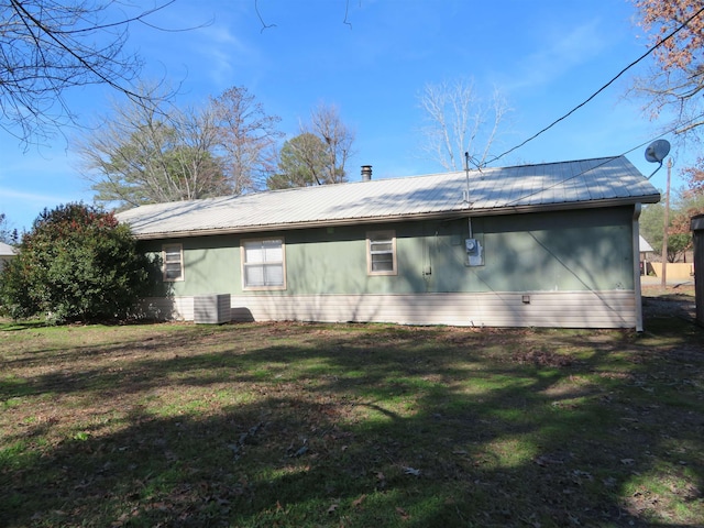 view of property exterior with a yard and central AC unit