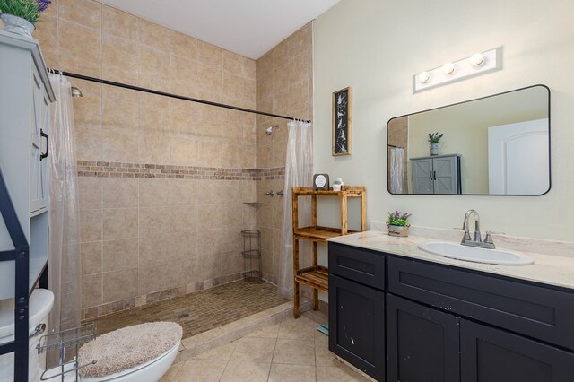 bathroom with tile patterned floors, toilet, curtained shower, and vanity