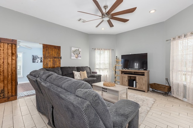 living room featuring ceiling fan and light wood-type flooring