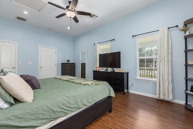 bedroom with dark hardwood / wood-style flooring and ceiling fan